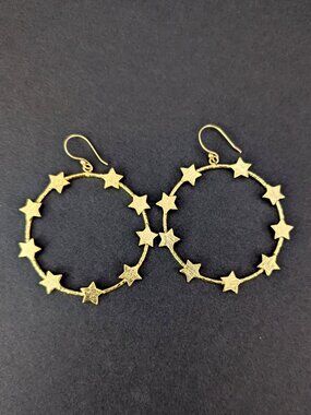 Gold tone hoop earrings with star accents